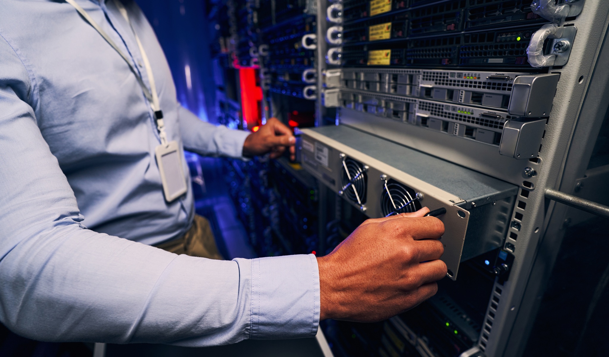 Engineer Carrying Out Data Center Equipment Upgrade Engineer Carrying Out Data Center Equipment Upgrade