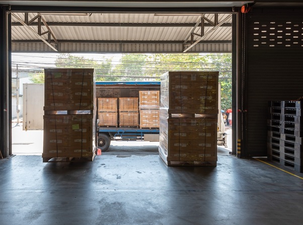 Loading Dock At Logistics Warehouse With Pallets