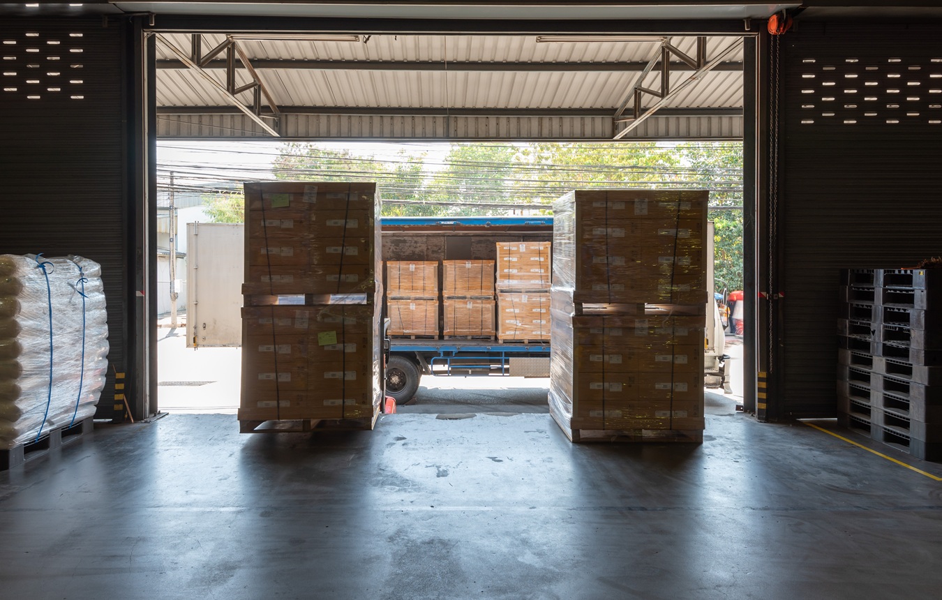Loading Dock At Logistics Warehouse With Pallets