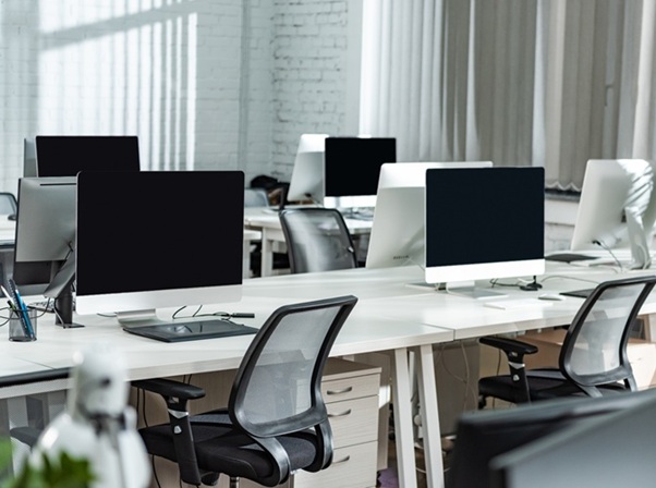 Modern Open Space Office With Computer Monitors On White Desks